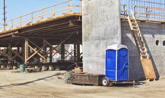 job site necessities a group of portable restrooms ready for use by the crew