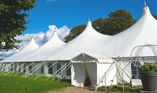 a line of sleek and modern portable toilets ready for use at an upscale corporate event in Montville